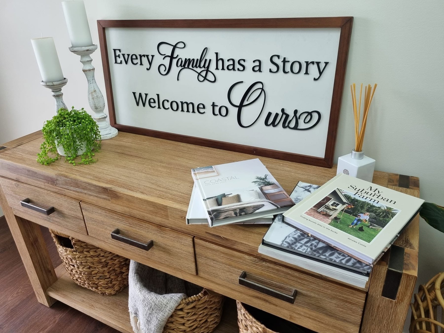 Framed timber family welcome sign styled on a timber console